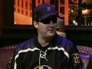 Tom Dwan giggling while Phil Hellmuth talks